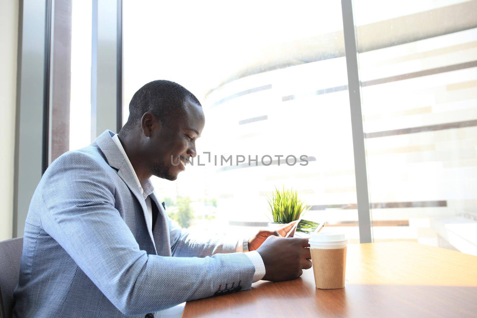 Image of african american businessman working on his touchpad