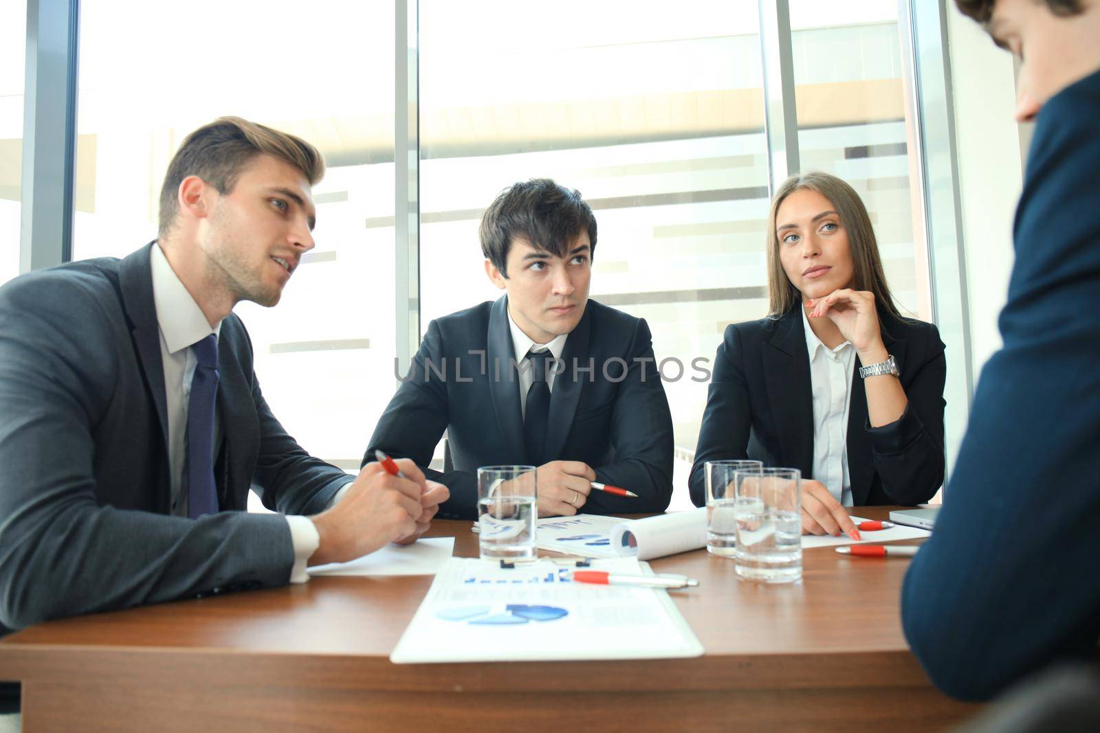Business people discussing together in conference room during meeting at office by tsyhun