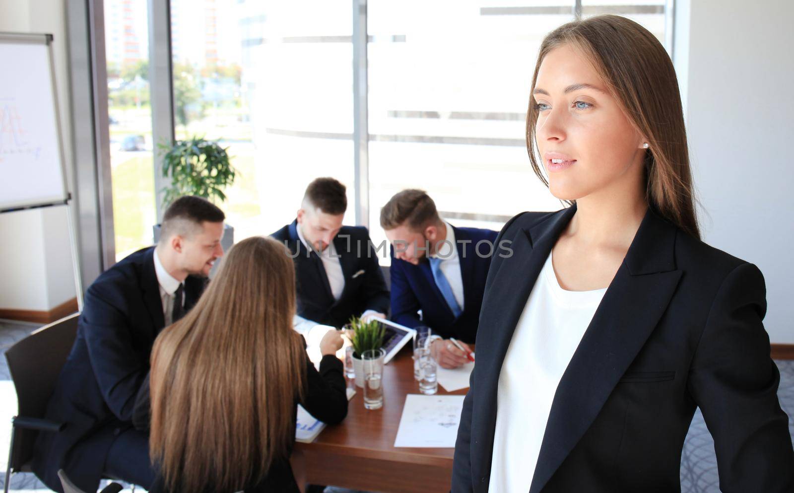Face of beautiful woman on the background of business people by tsyhun