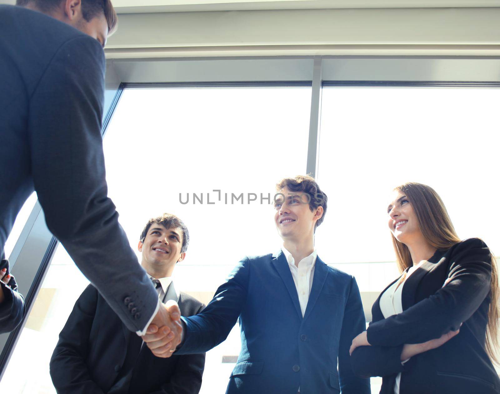 Business people shaking hands, finishing up a meeting by tsyhun