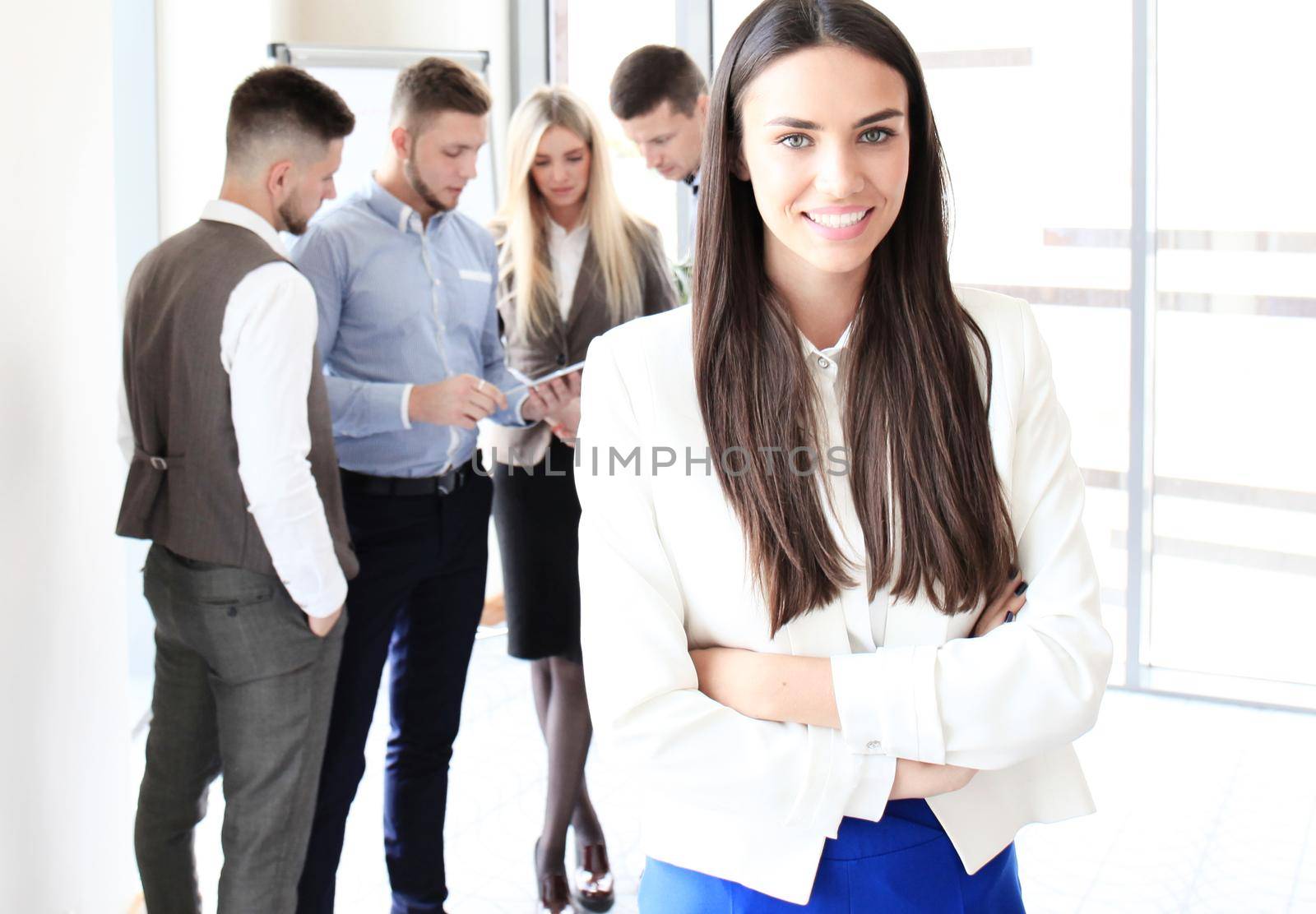 Face of beautiful woman on the background of business people by tsyhun