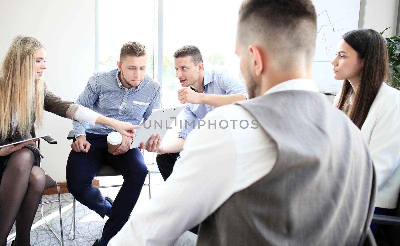 Business team discussing together business plans in office by tsyhun