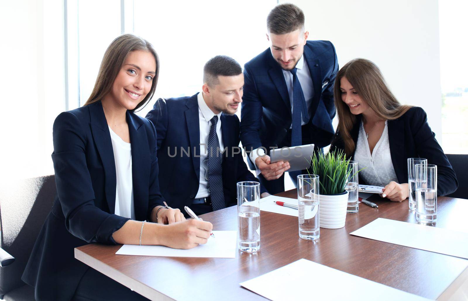 business woman with her staff, people group in background at modern bright office indoors