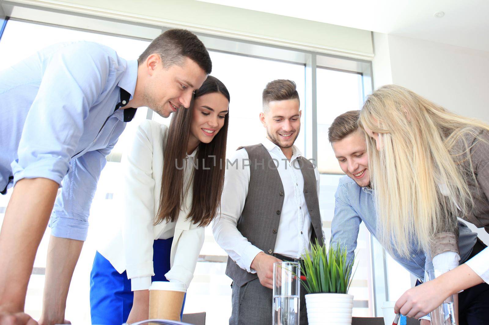 Business team discussing together business plans in office by tsyhun