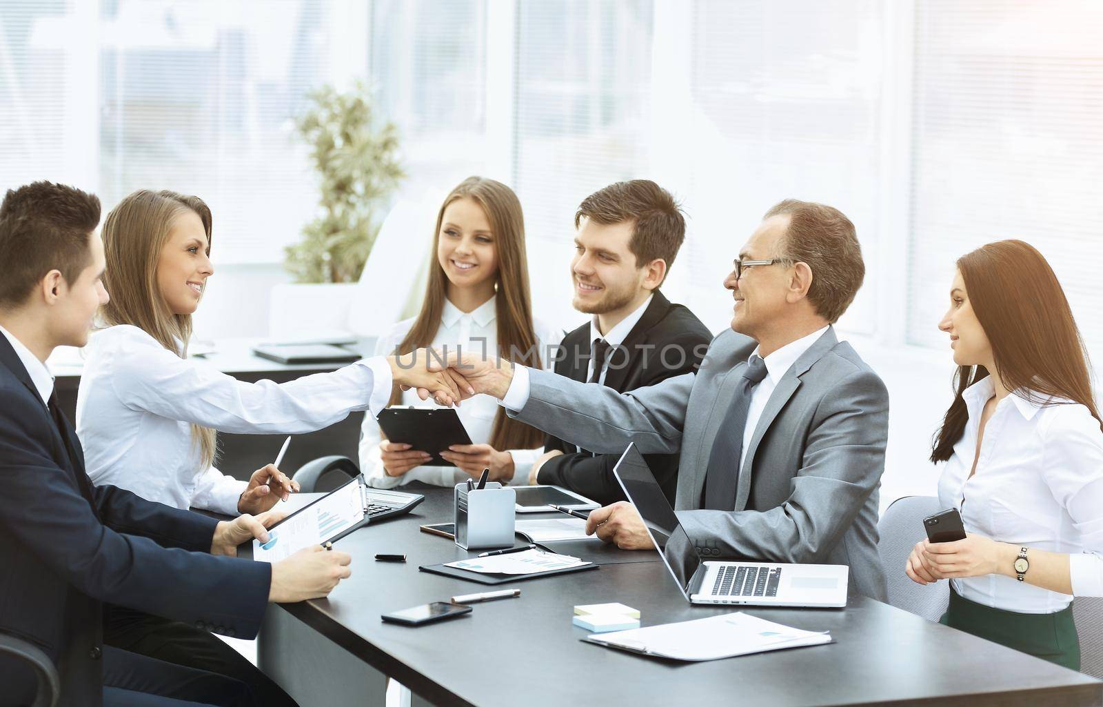 group of businessmen discussing the policies the company shaking hands with each other