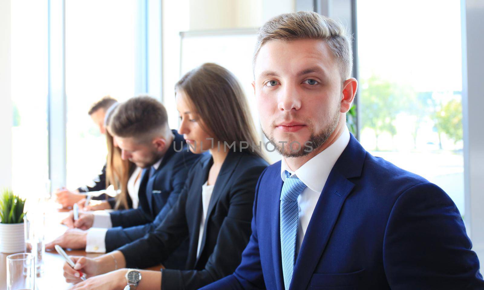 Businessman with colleagues in the background in office by tsyhun
