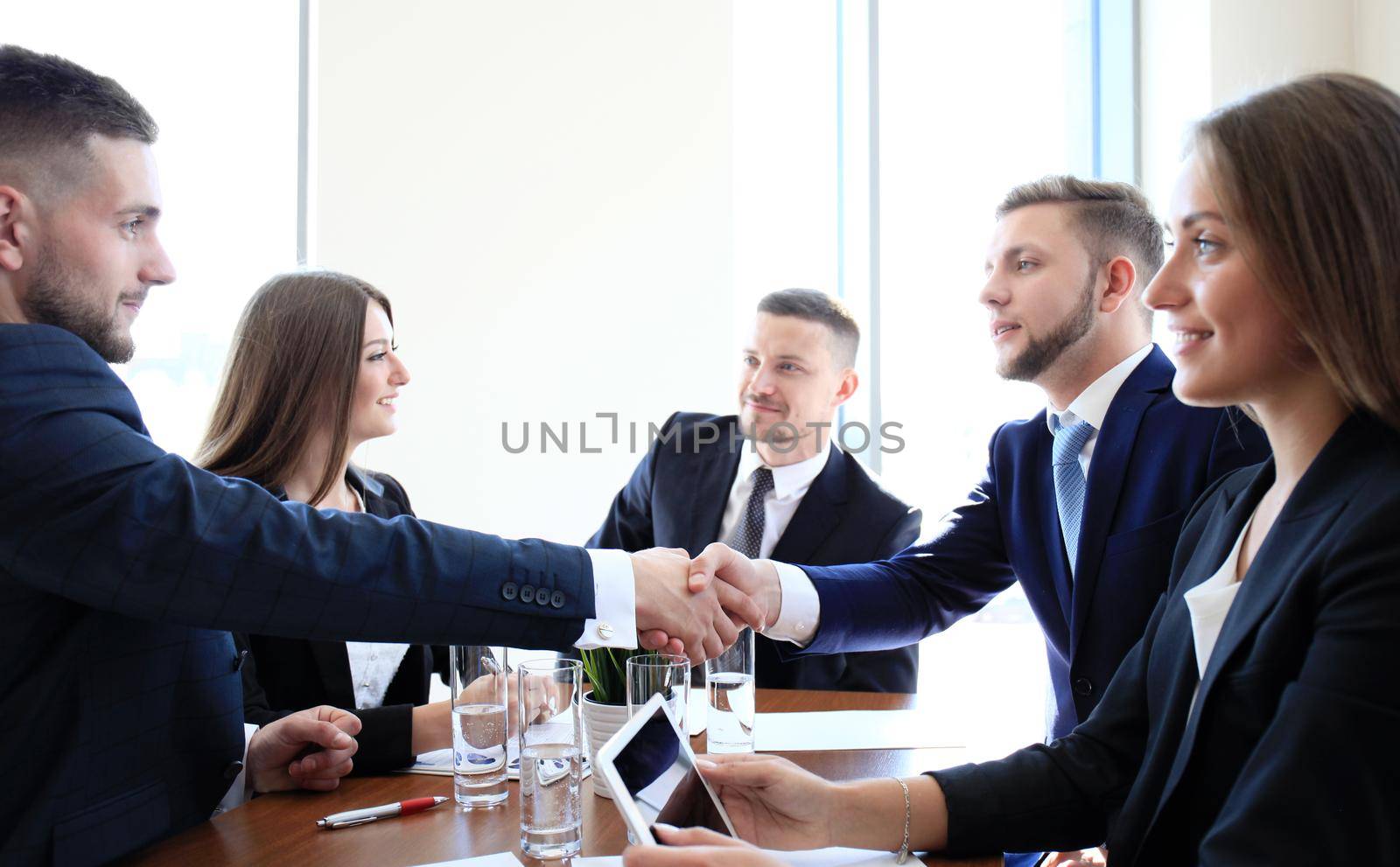 Business people shaking hands, finishing up a meeting by tsyhun