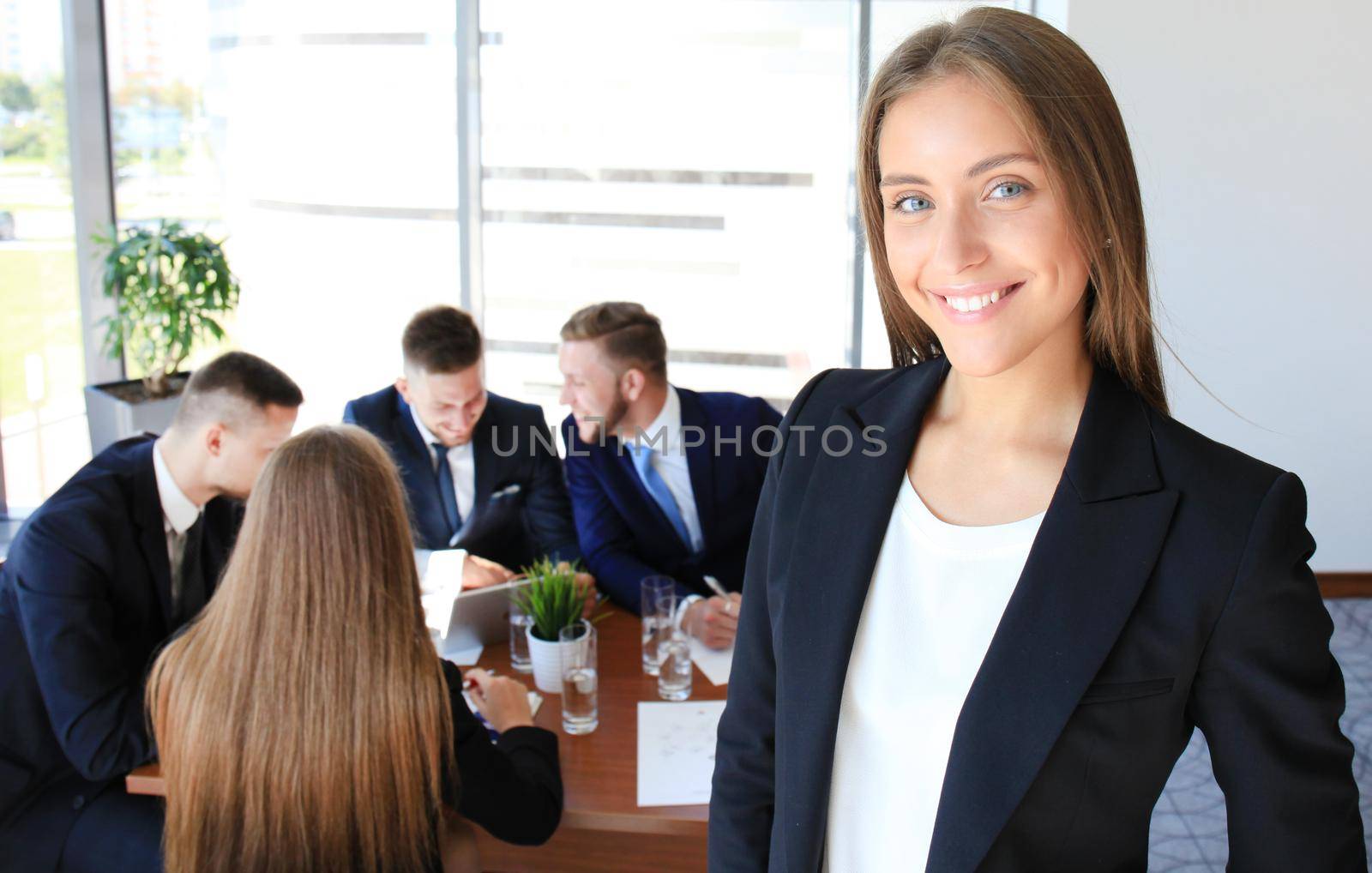 Face of beautiful woman on the background of business people