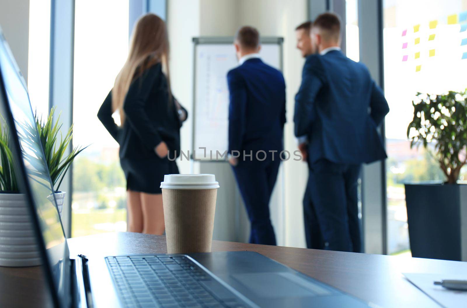 Team young professionals having casual discussion in office. Executives having friendly discussion during break.