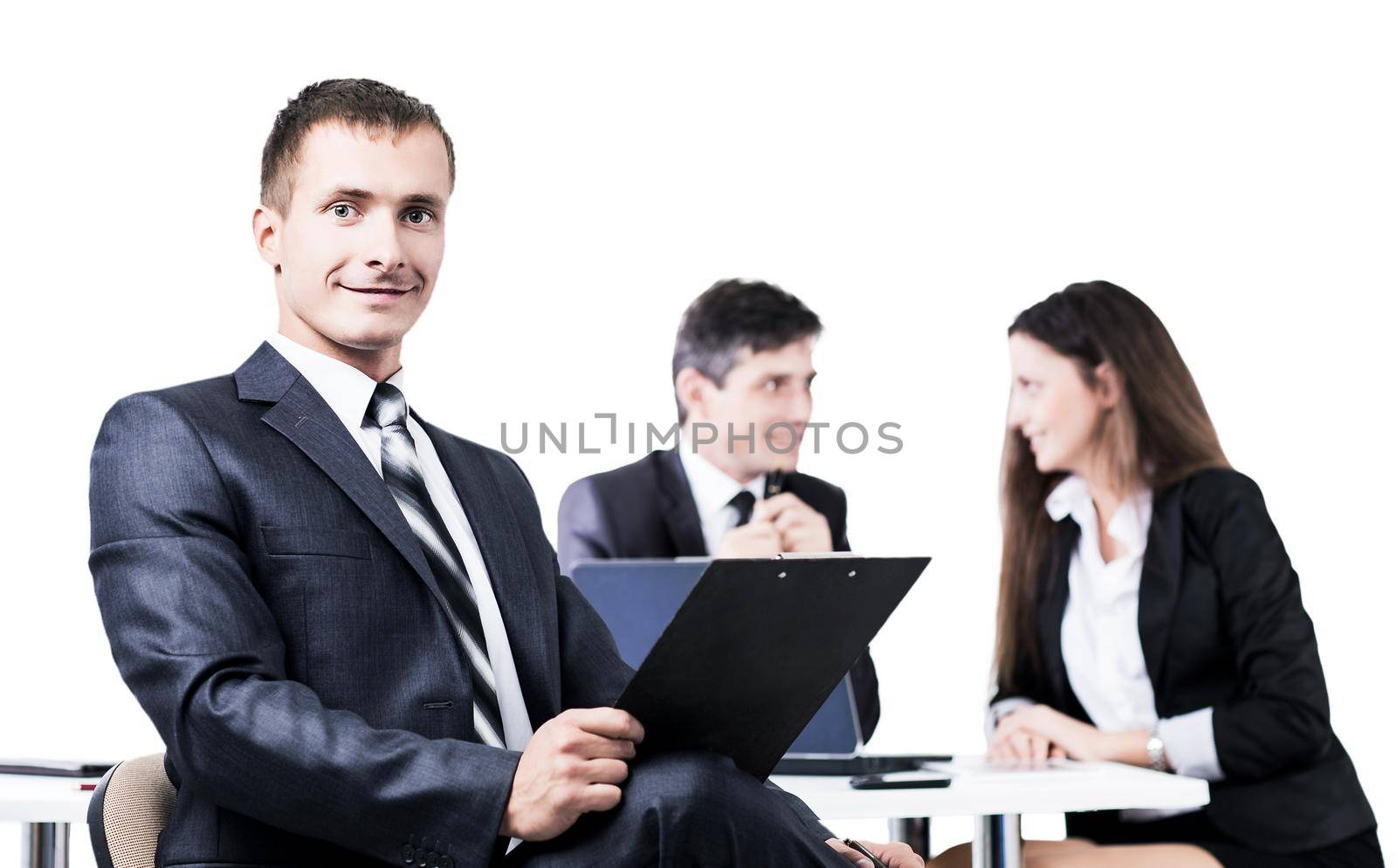 Portrait of a young businessman on background working team by SmartPhotoLab