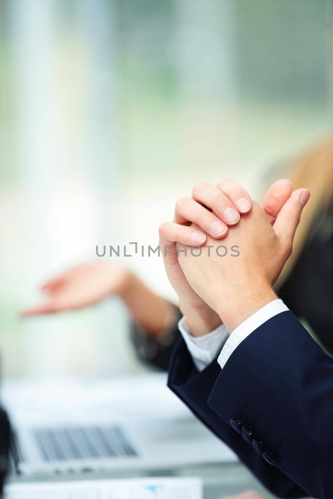 close-up of hands of a businessman on the desktop during the discussion