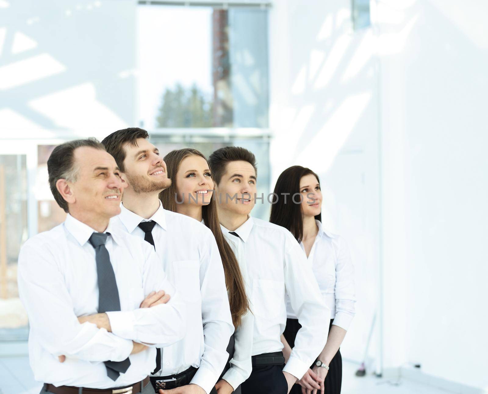 Group of friendly businesspeople with happy female leader in front