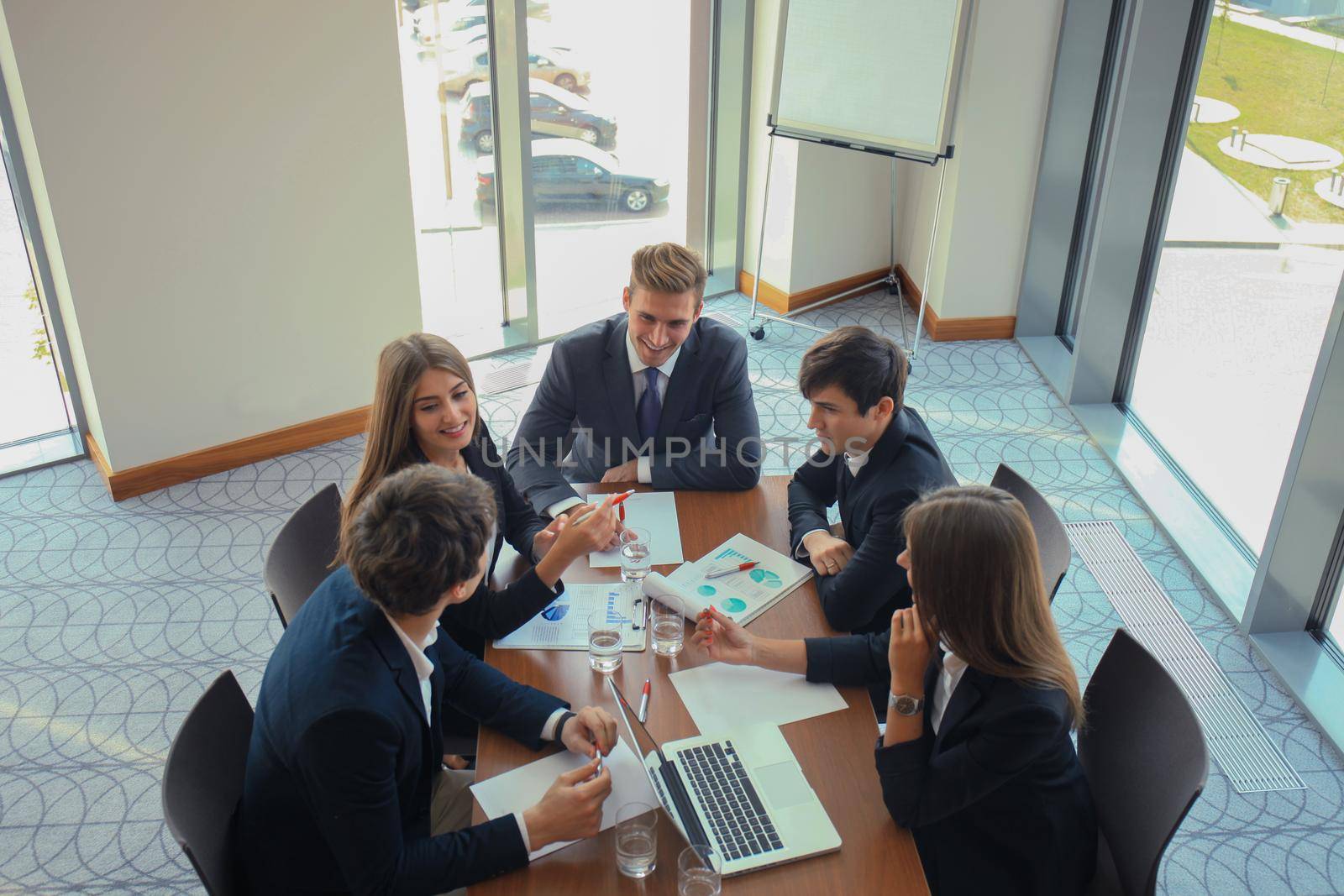 startup business team on meeting in modern bright office interior brainstorming, working on laptop and tablet computer