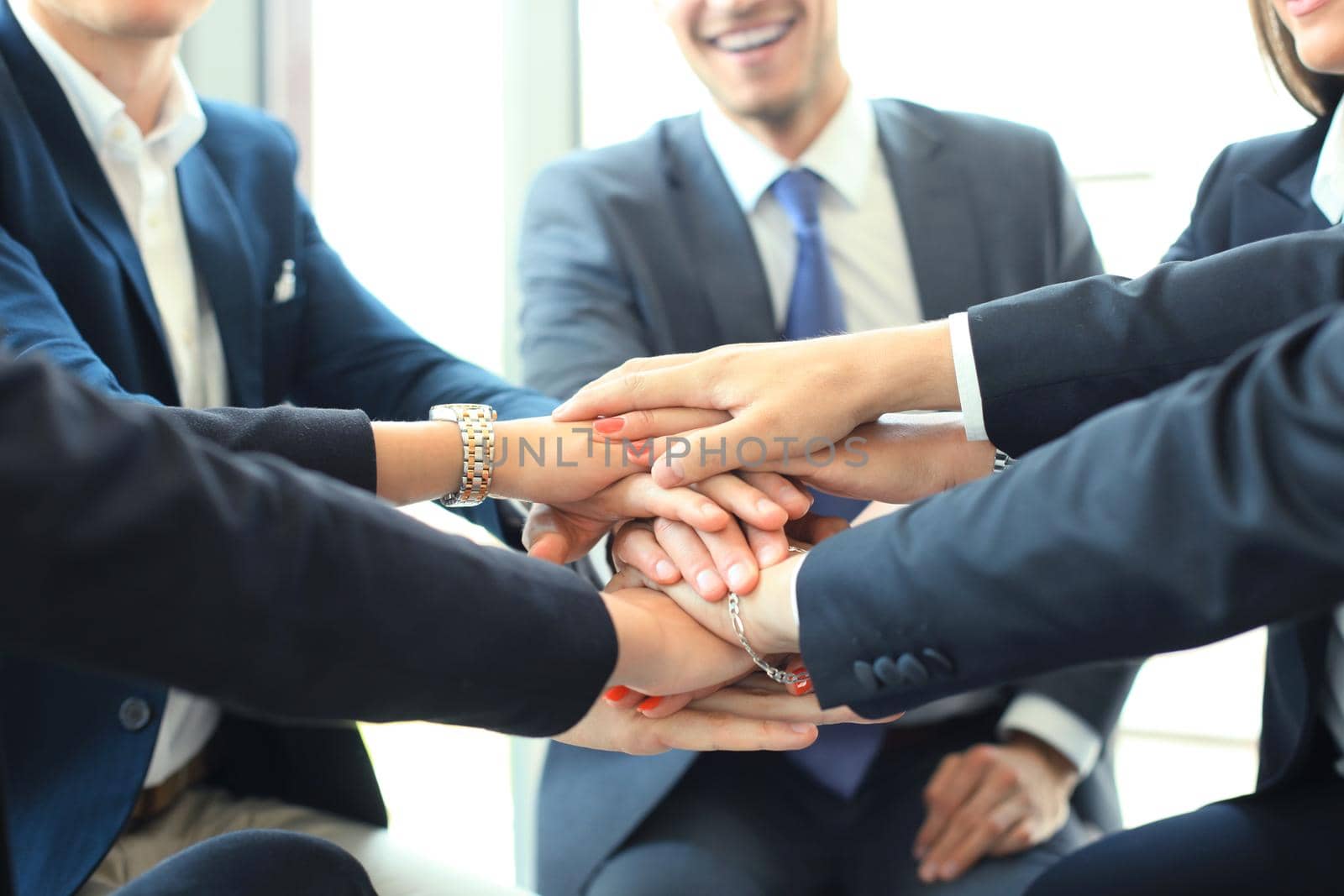Group of businessman team touching hands together. Selective focus. by tsyhun