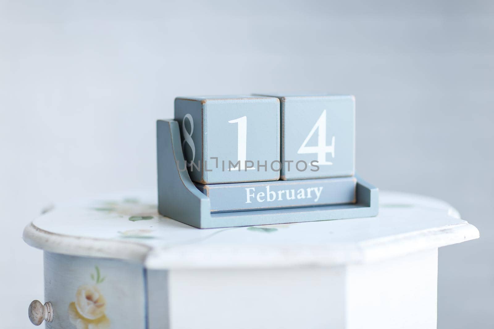 stylish Desk calendar with the words 'February 14' on the bedside table. the photo has a empty space for your text