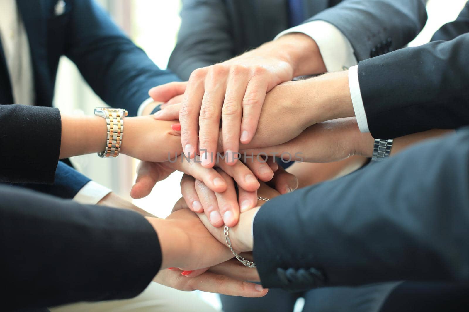 Group of businessman team touching hands together. Selective focus. by tsyhun