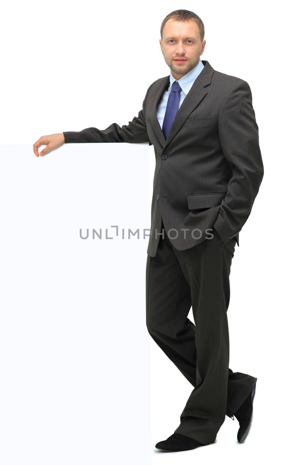 Portrait of happy smiling young business man showing blank signboard, isolated over white background by tsyhun