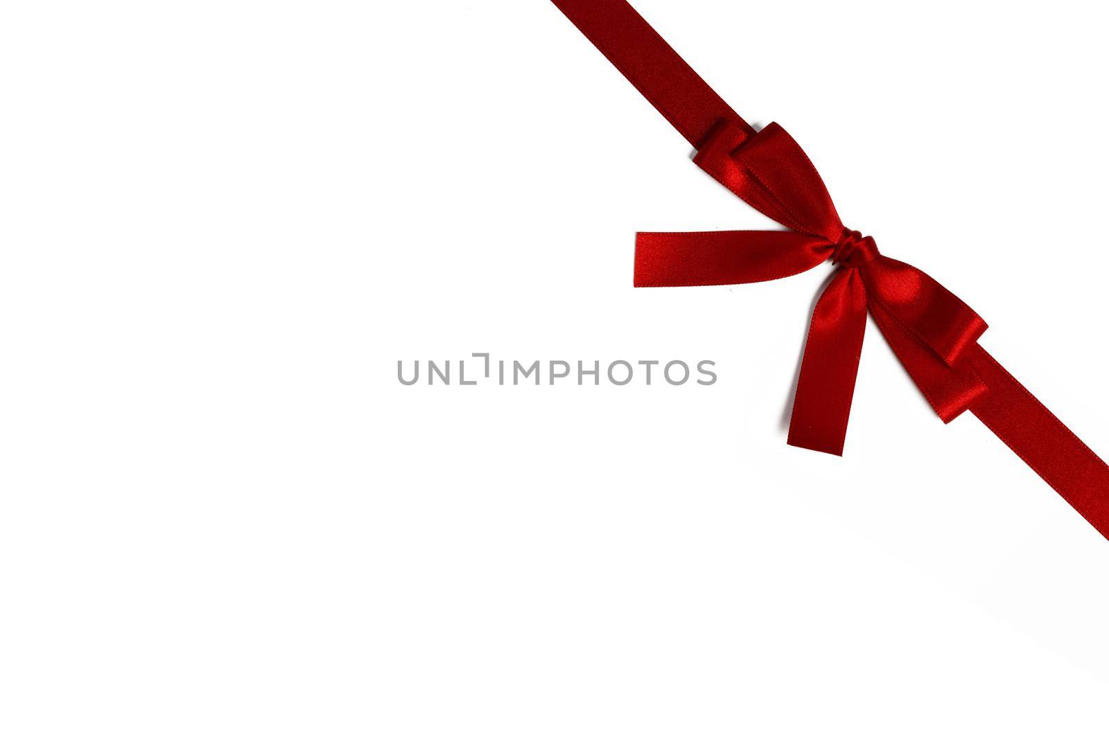 Elegant satin red ribbon bow isolated on white background