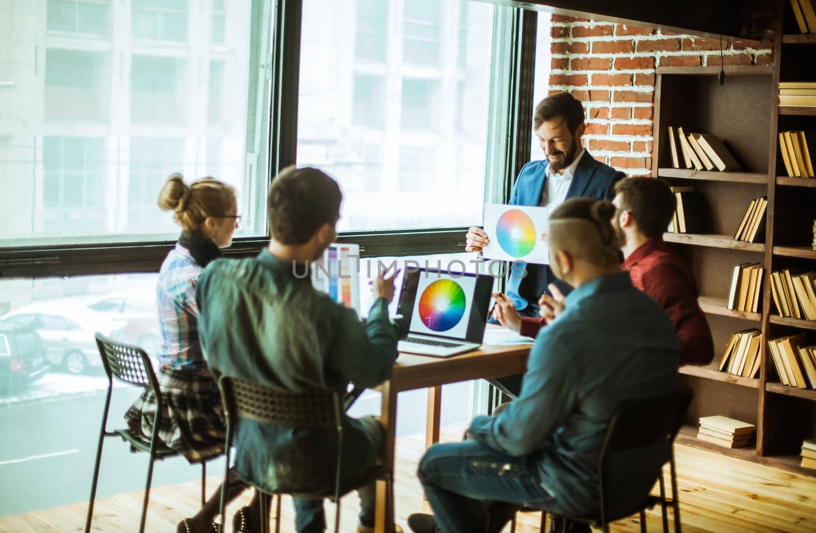 group of designers discussing a new color palette in the workplace in a modern office.