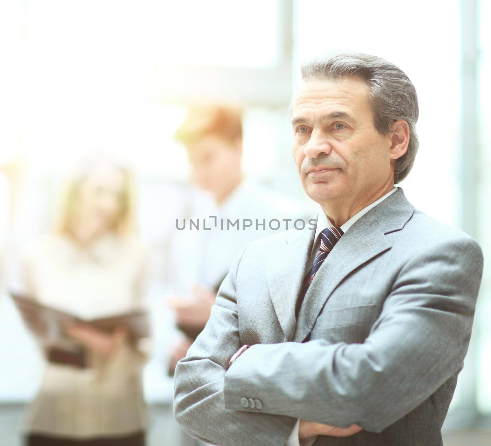 Happy smart business man with team mates discussing in the background
