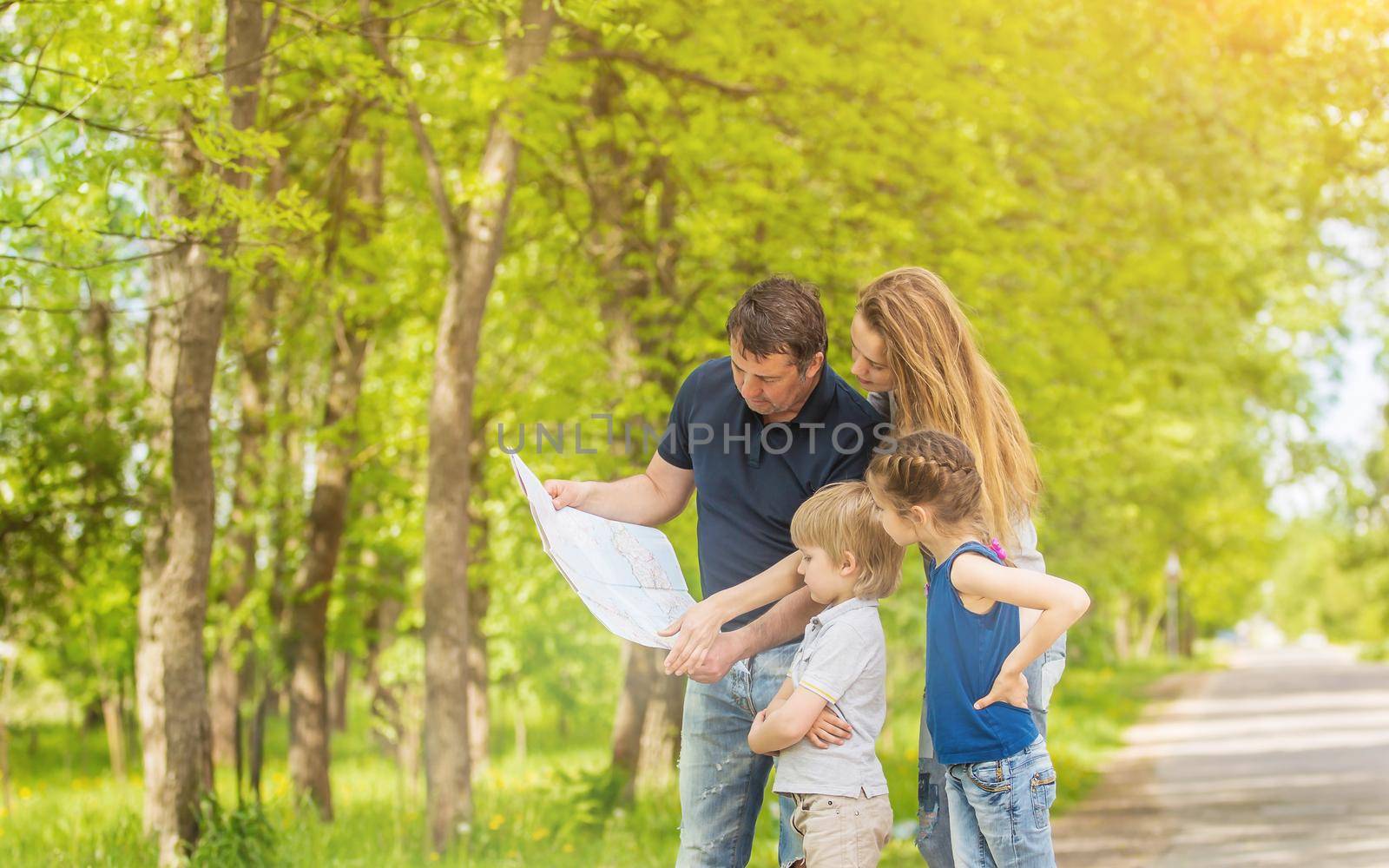 Family on vacation in the park exploring the local attractions on the map
