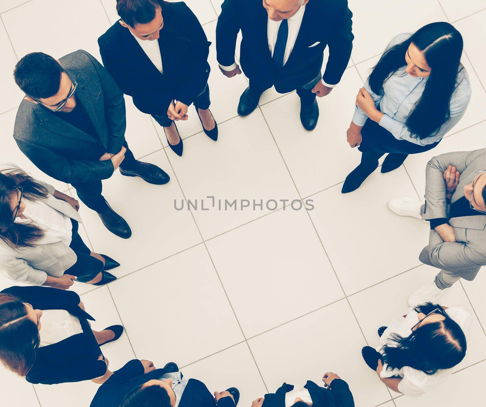 top view. group of business people standing in a circle. the concept of team building
