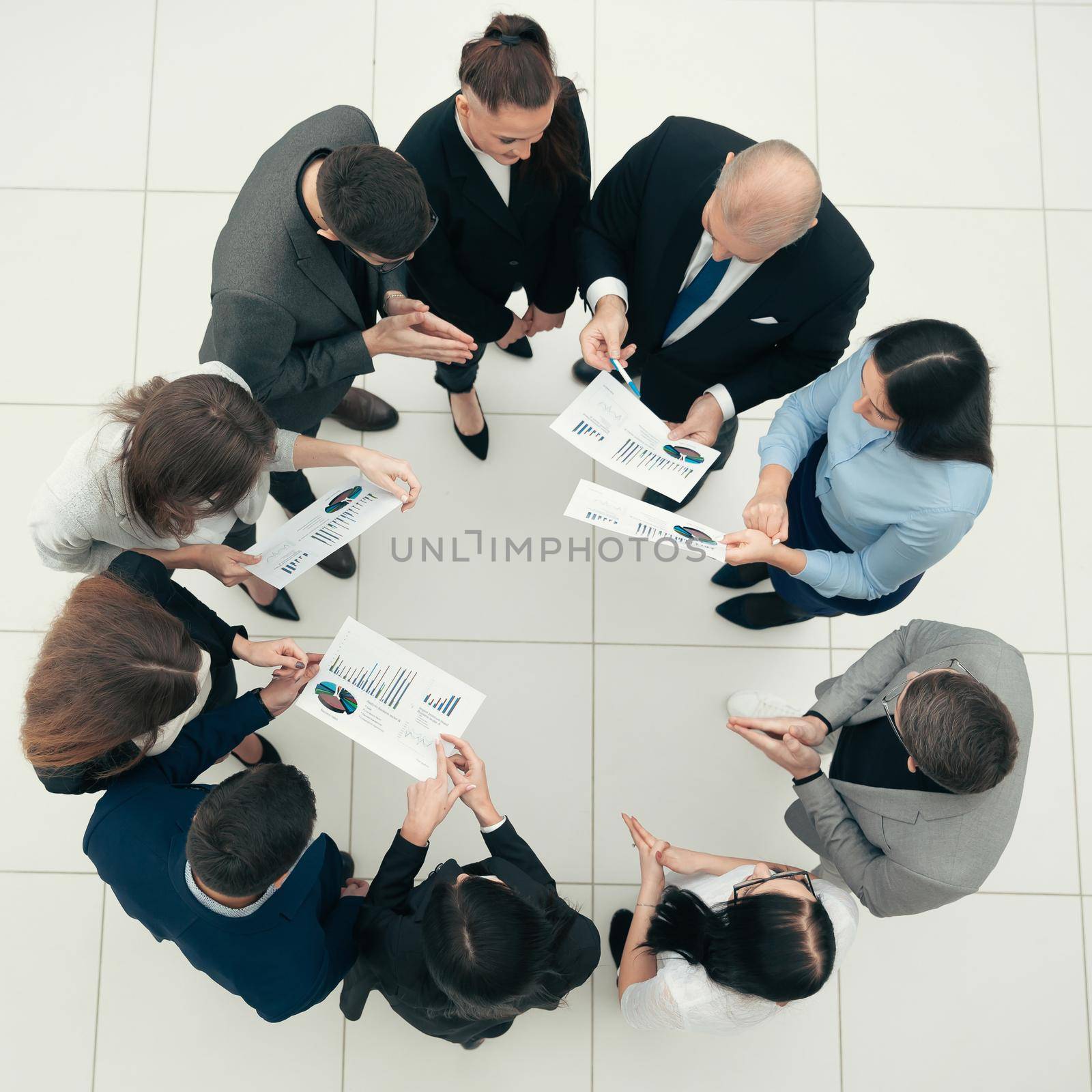 top view. group of corporate employees standing in a circle. by SmartPhotoLab