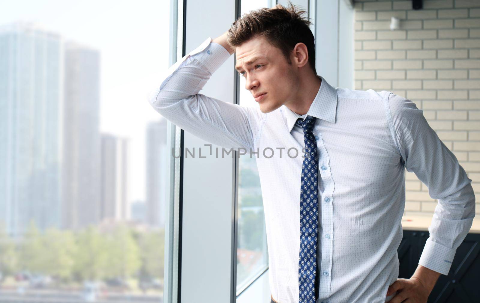 Young handsome businessman smiling in an office environment