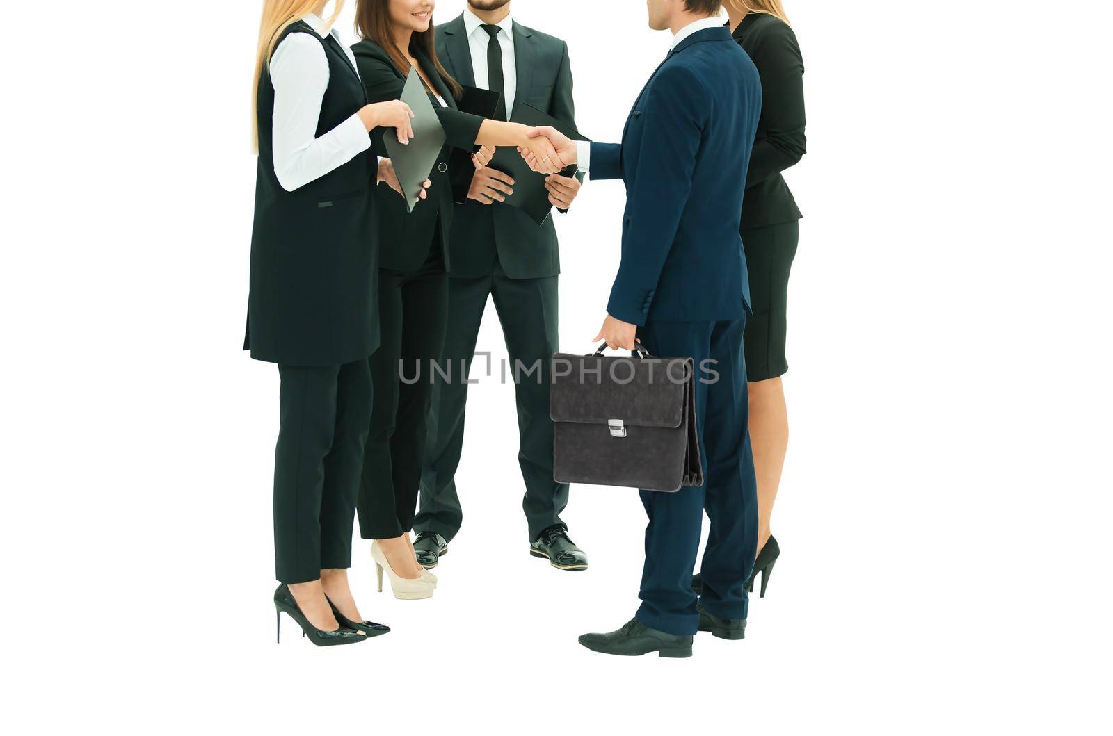 in the foreground: business partners shaking hands at the meeting. isolated on white background