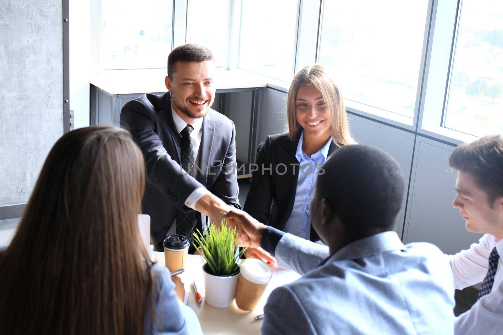 Business handshake. Business people shaking hands, finishing up a meeting by tsyhun