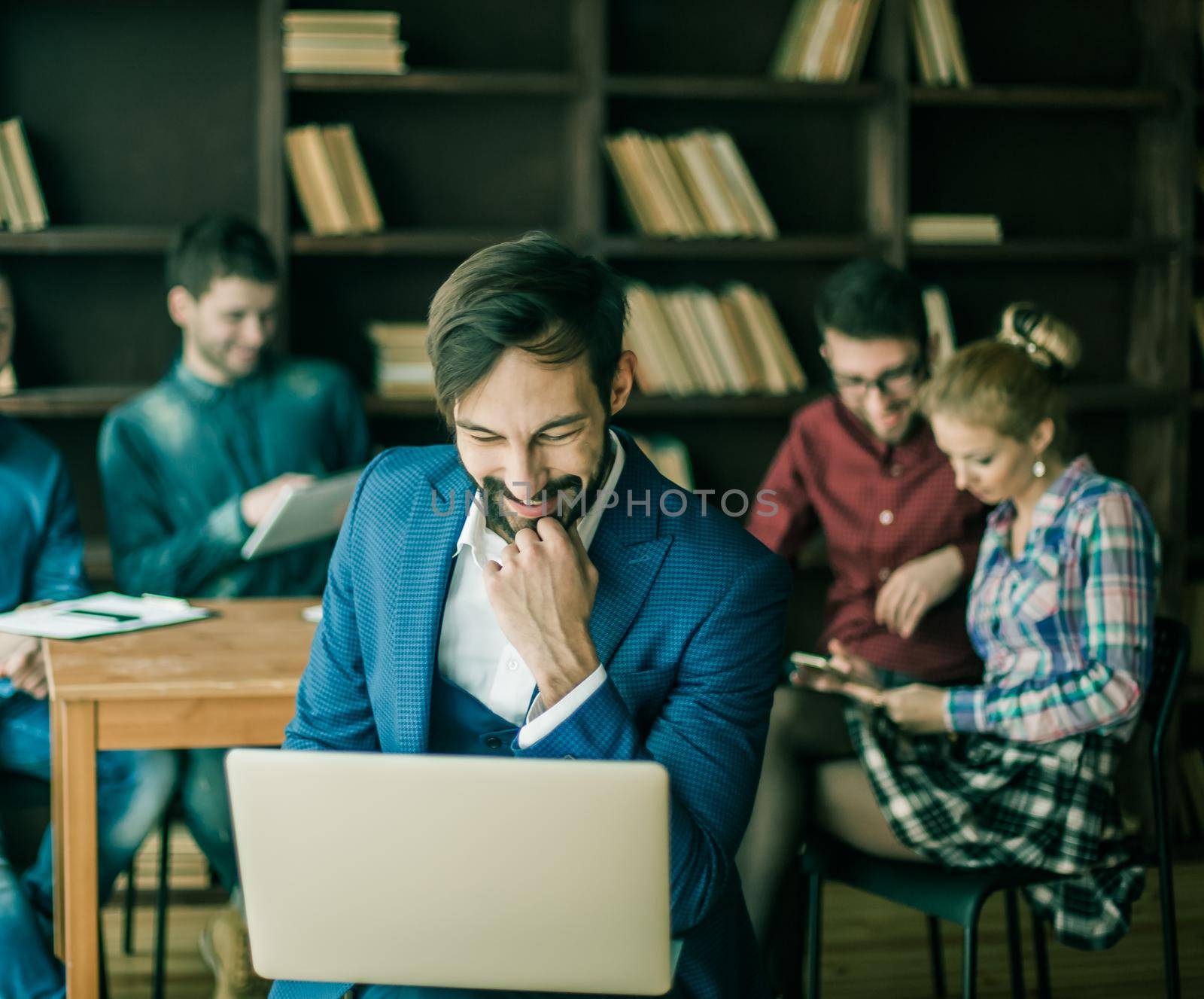 sales Manager with a laptop and a business team discussing the current problems of the company