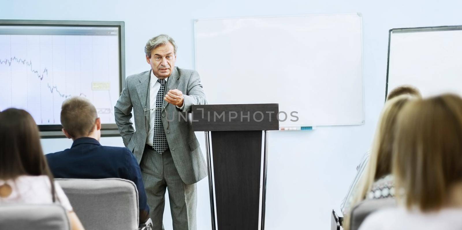 Businessman giving a presentation at the conference. teamwork concept by SmartPhotoLab