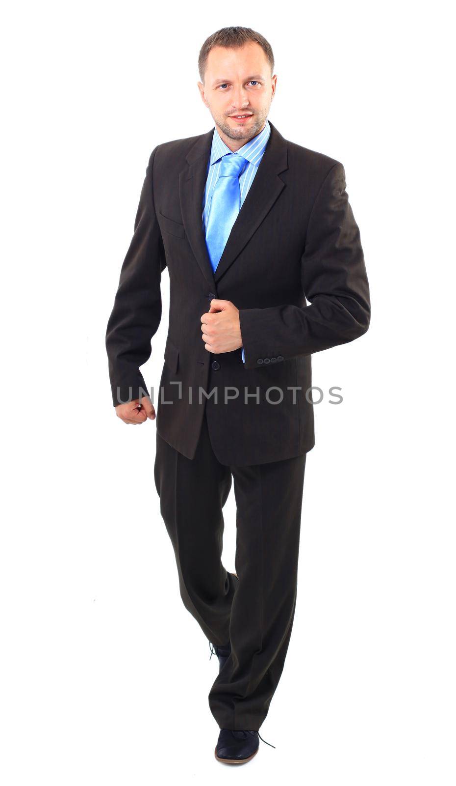 young businessman is walking. He is smiling and looking to the camera. isolated over white background
