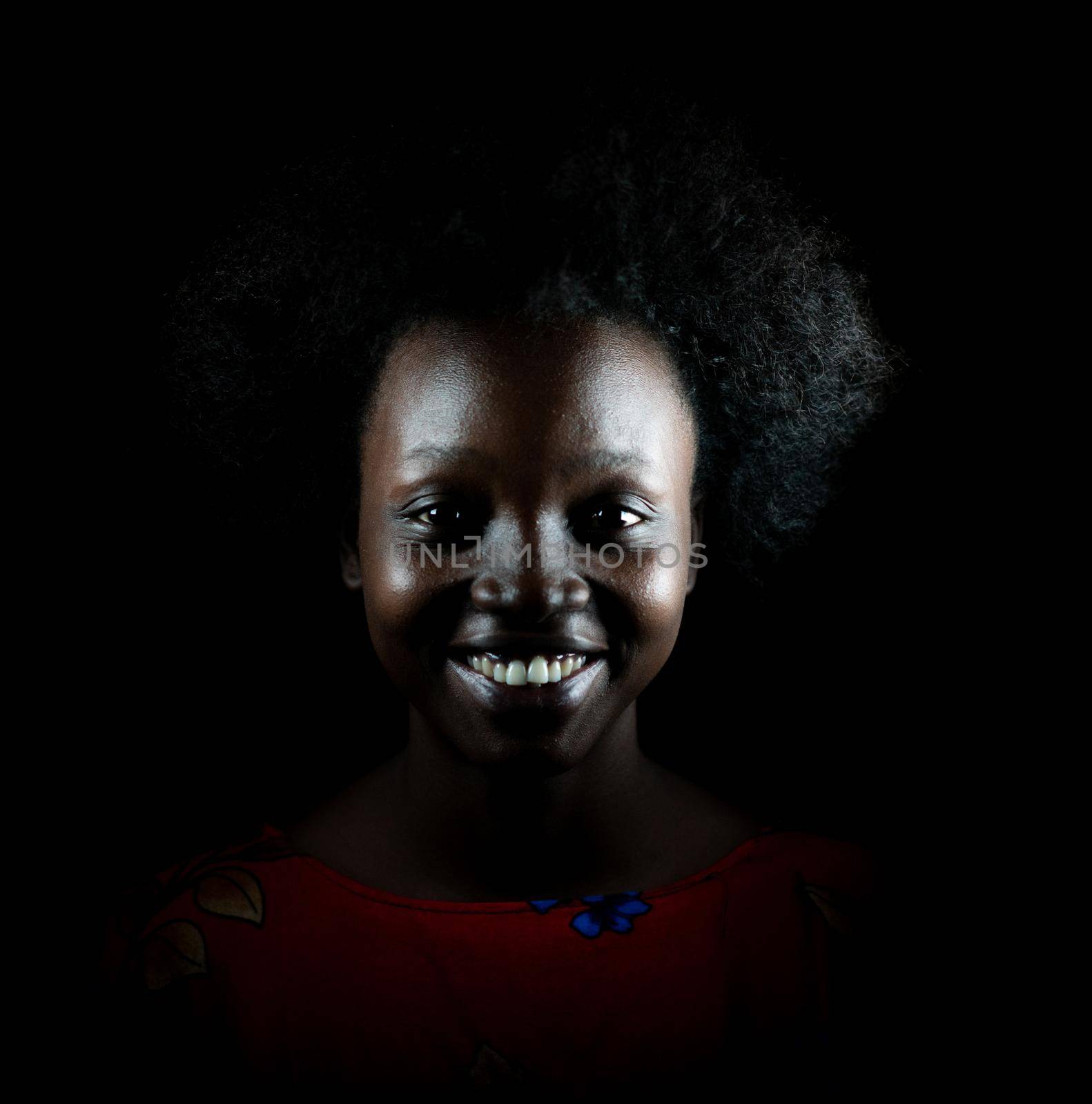 Dark portrait of young black woman in studio