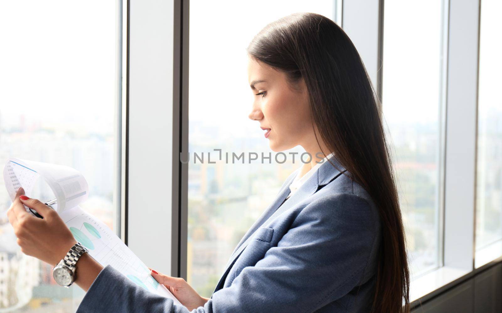 Modern business woman in the office with copy space by tsyhun