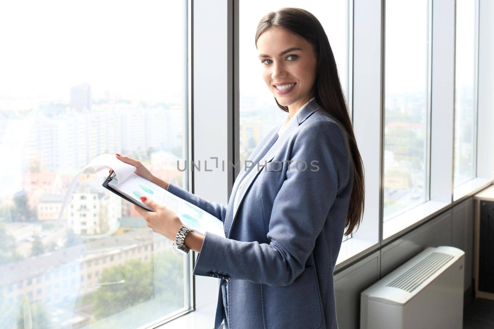 Modern business woman in the office with copy space by tsyhun