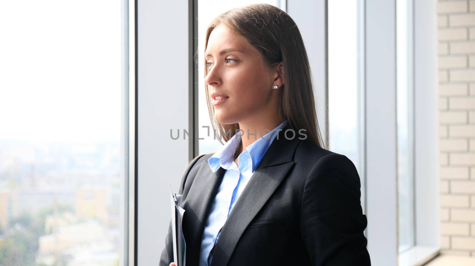 Modern business woman in the office with copy space by tsyhun