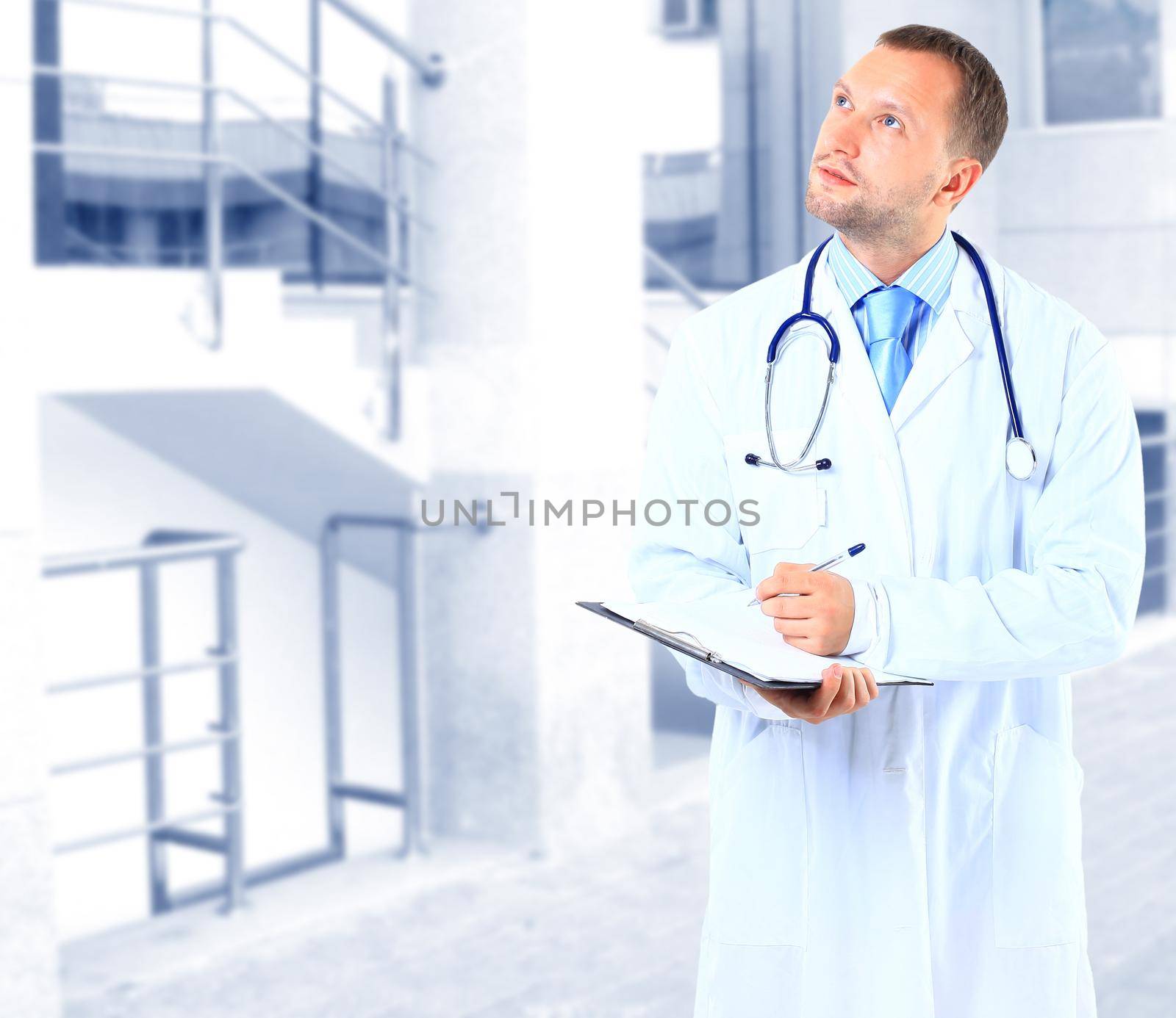portrait of doctor in white coat and stethoscope with arms crossed by tsyhun