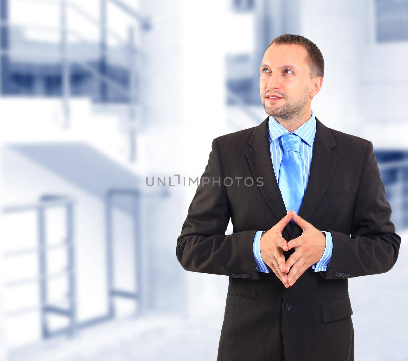 Businessman standing on white background, looking off into distance by tsyhun