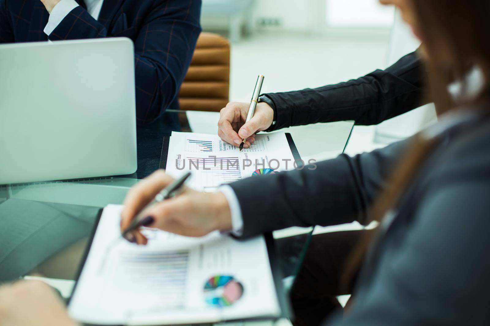 closeup of business team discussing financial charts on a workplace in a modern office