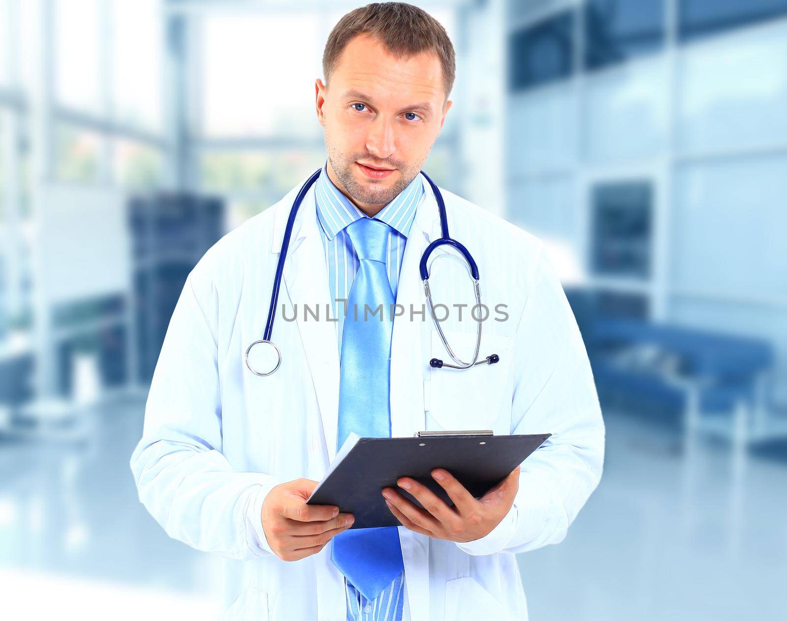 portrait of doctor in white coat and stethoscope with arms crossed