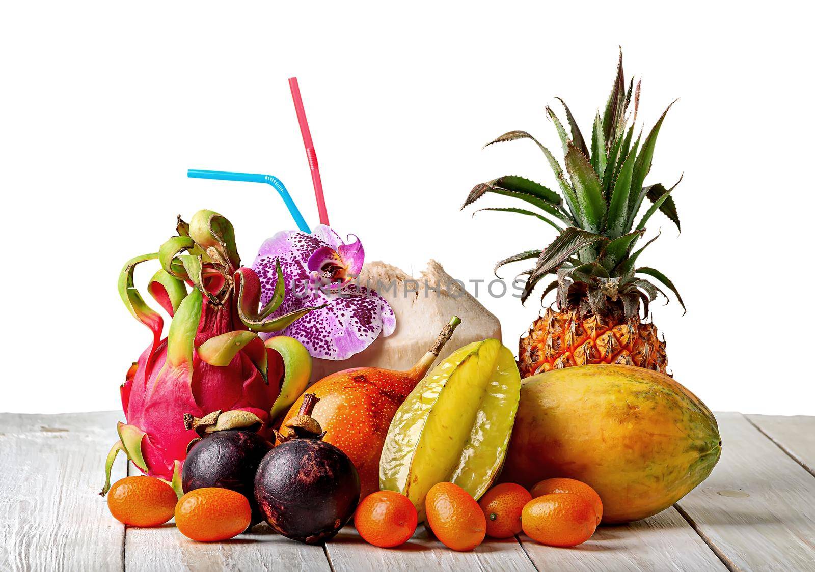 Tropical fruits on wooden table isolated on white background