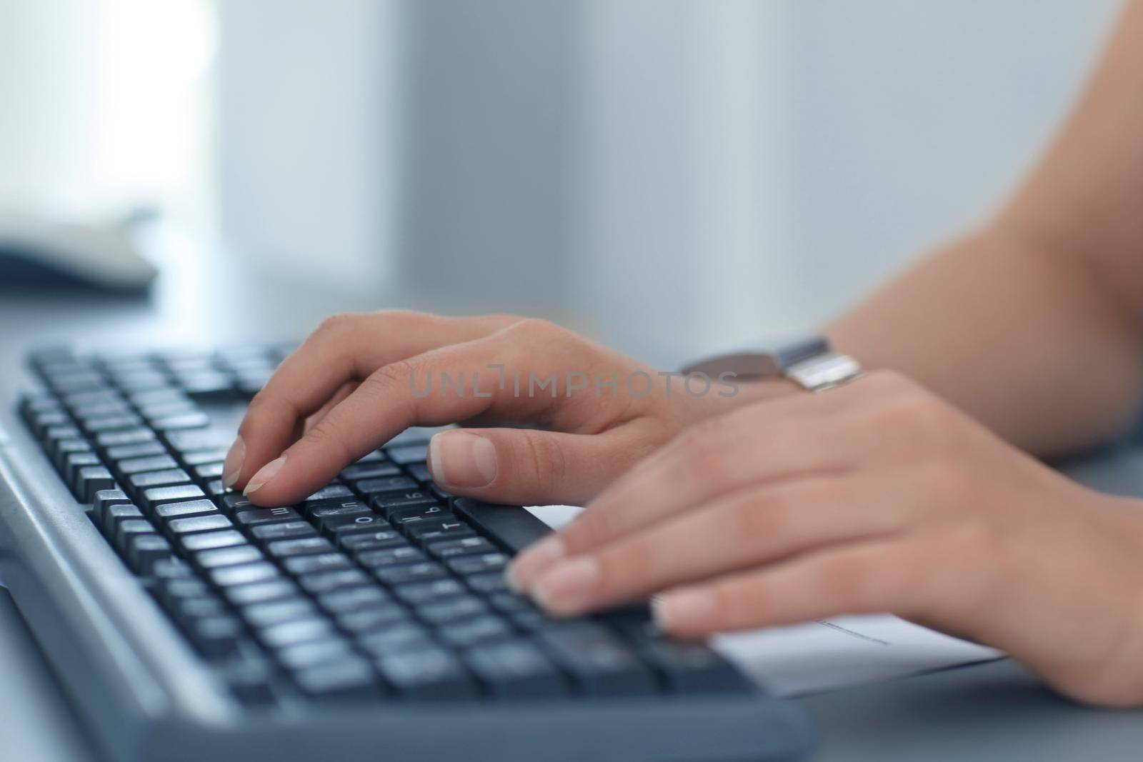 Close-up Of Female Hand Typing On Keyboard