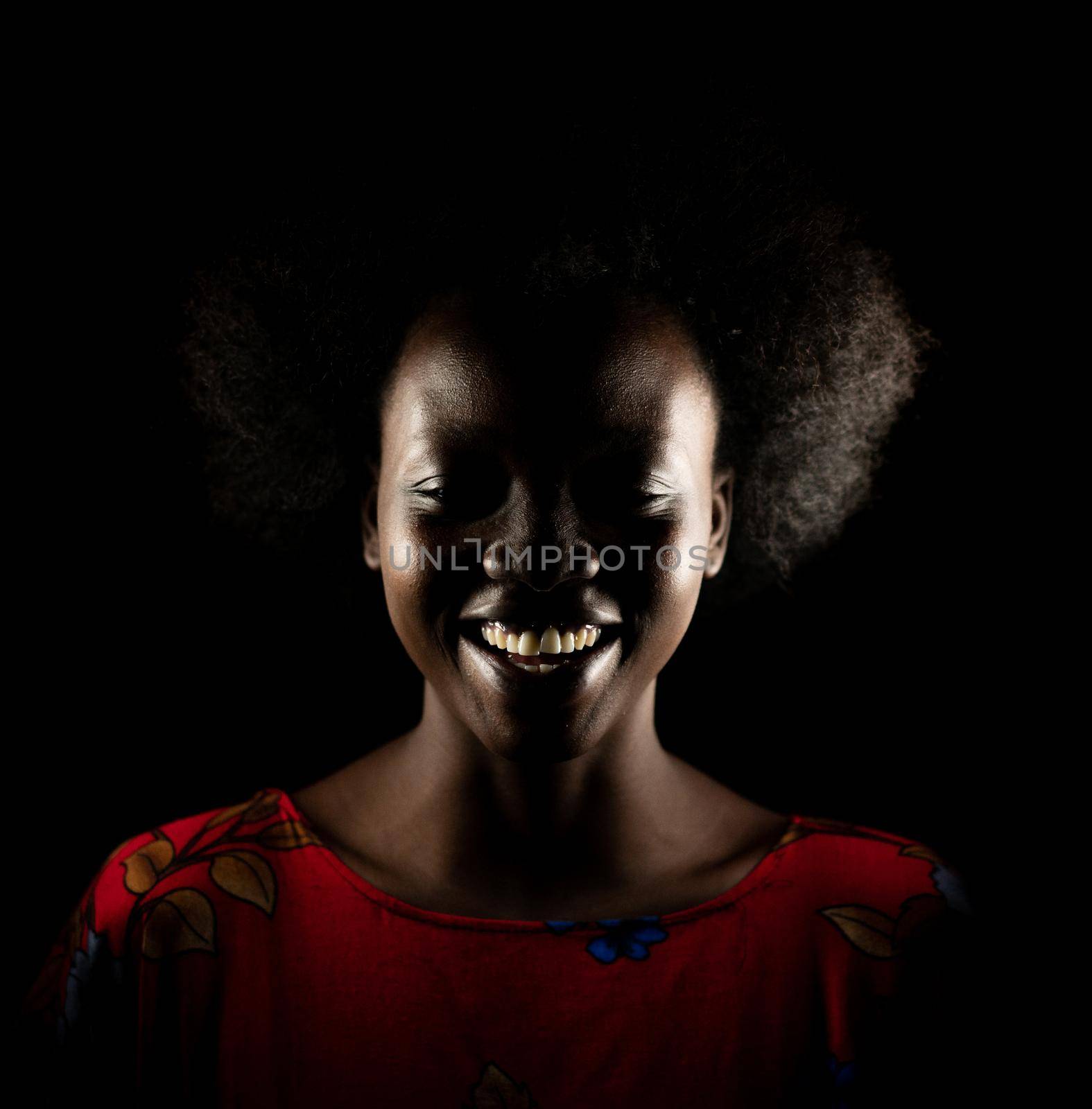 Dark portrait of young black woman in studio