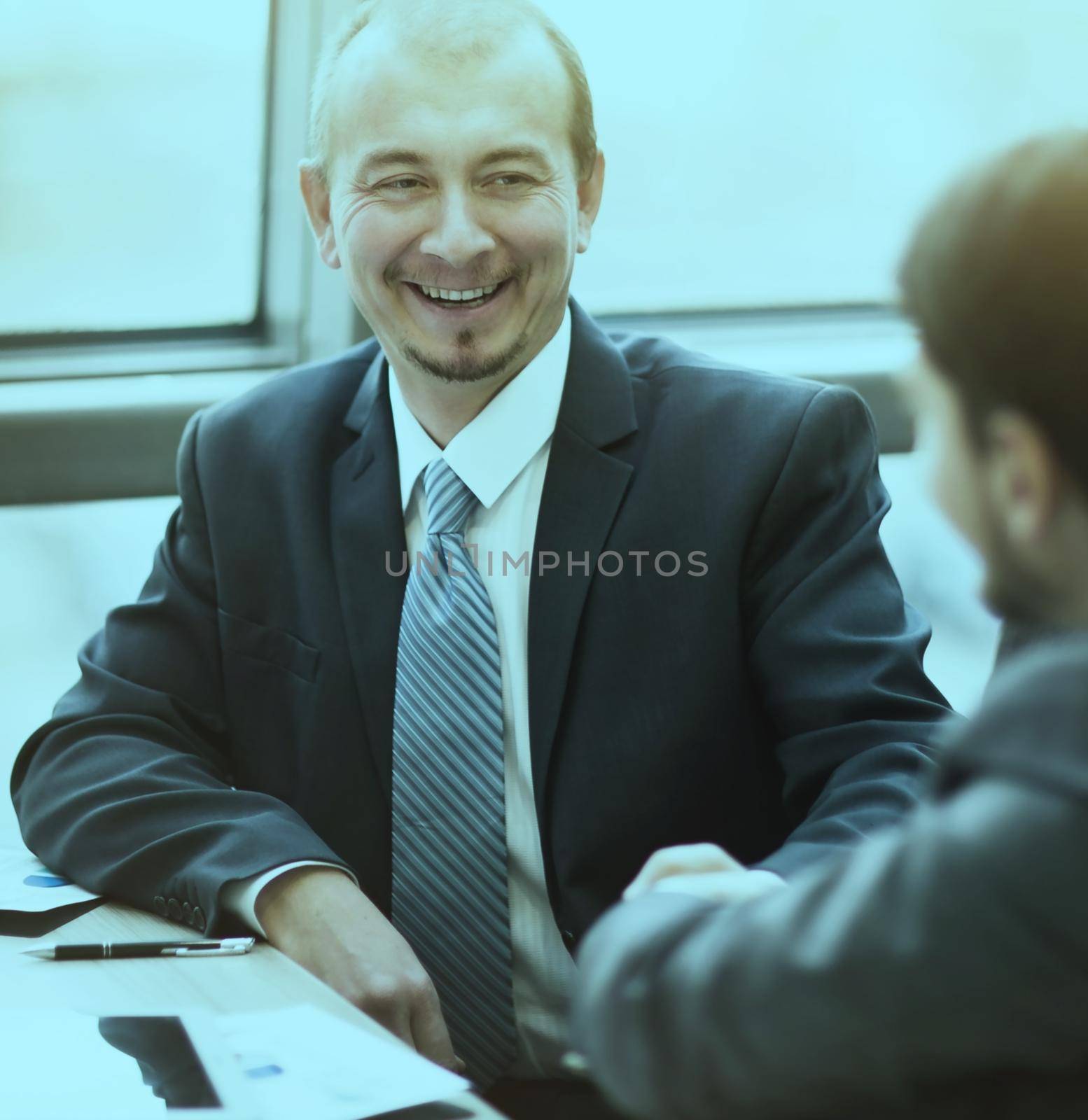 Business people shaking hands, finishing up a meeting, in the office by SmartPhotoLab