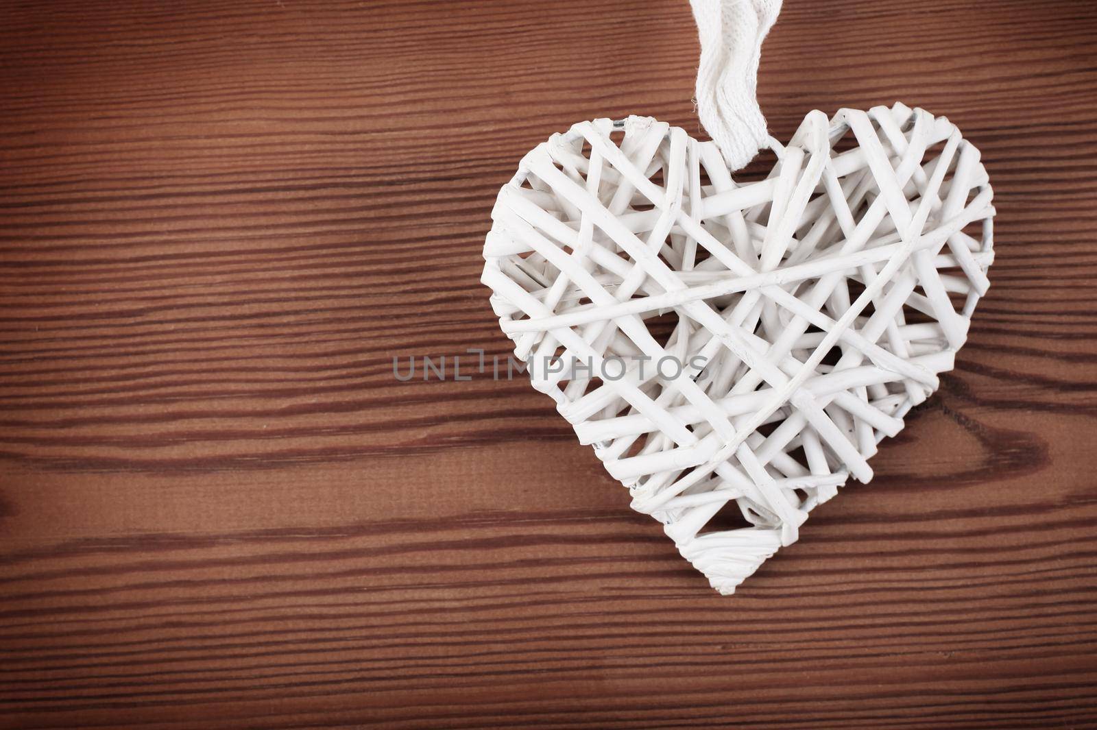Christmas toy heart on grunge wooden background. Winter holidays concept by tsyhun