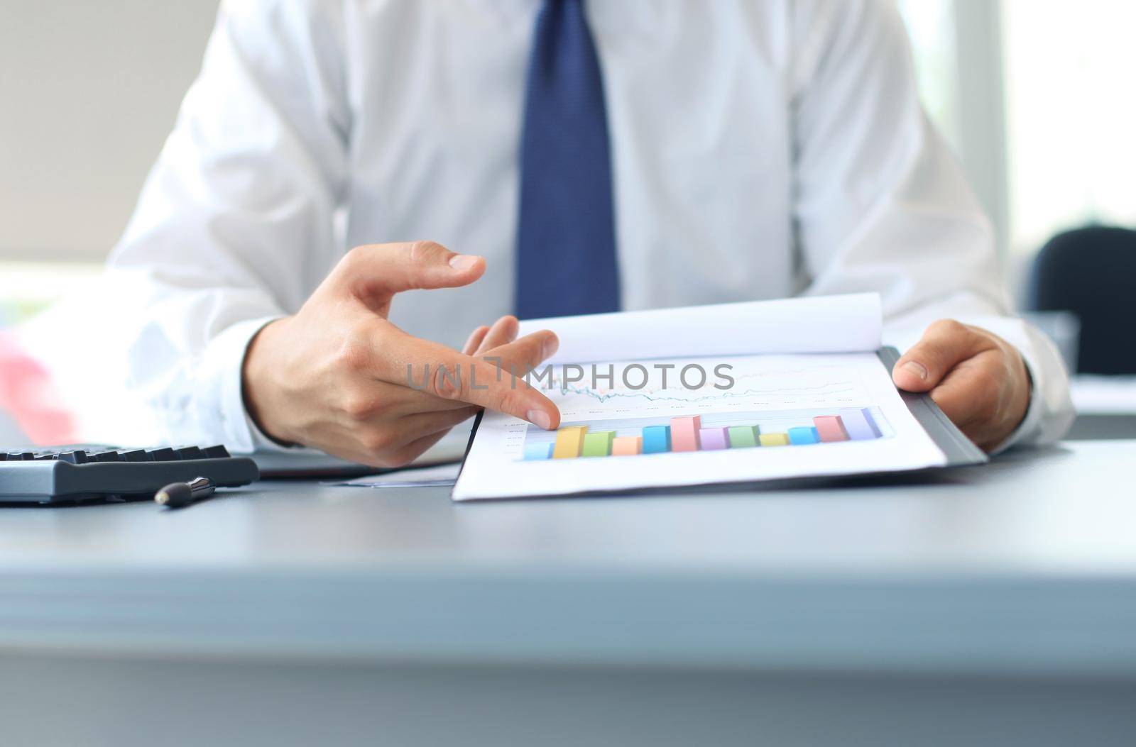 Close-up of graphs and charts analyzed by businessman