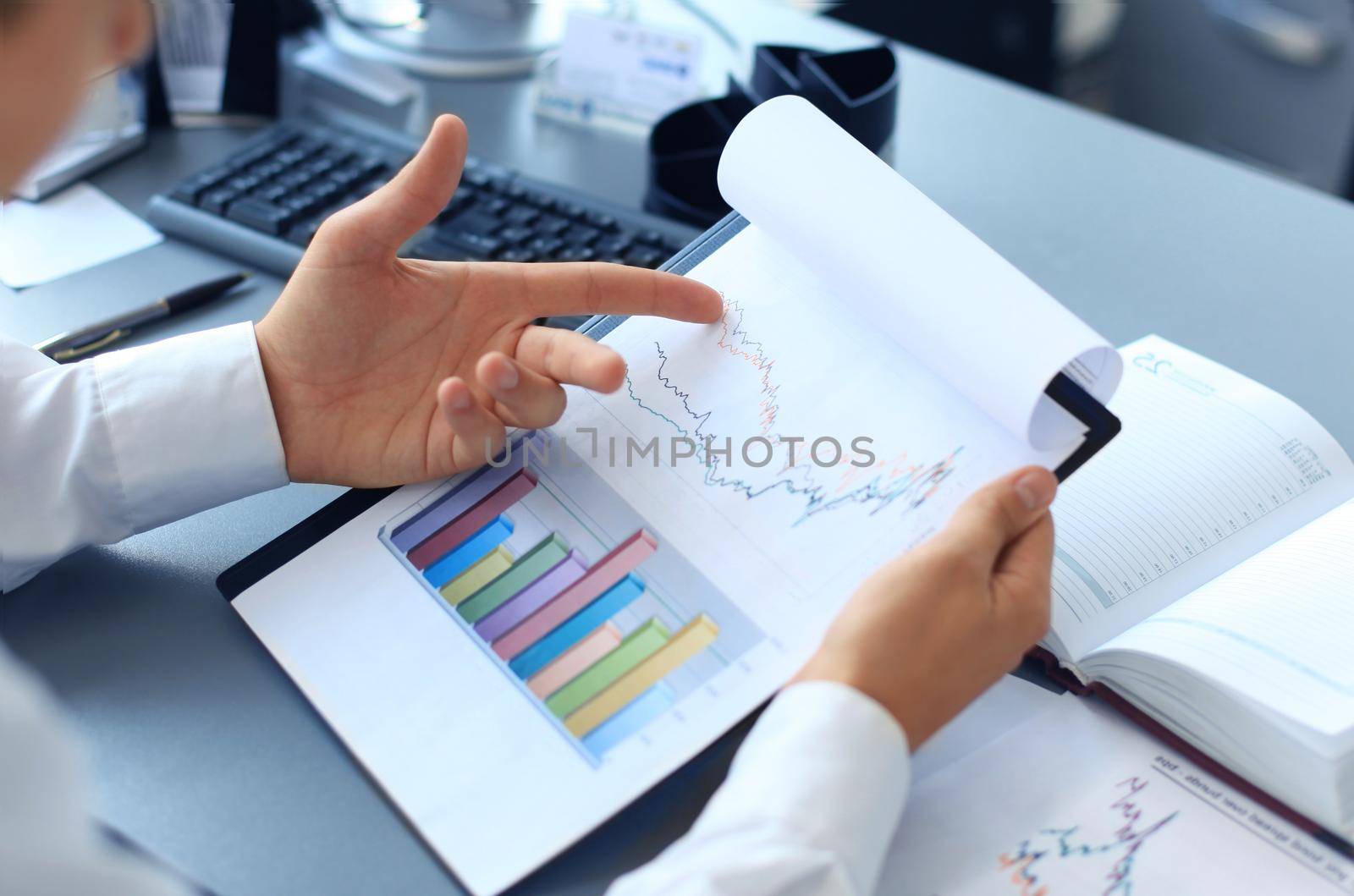 Close-up of graphs and charts analyzed by businessman