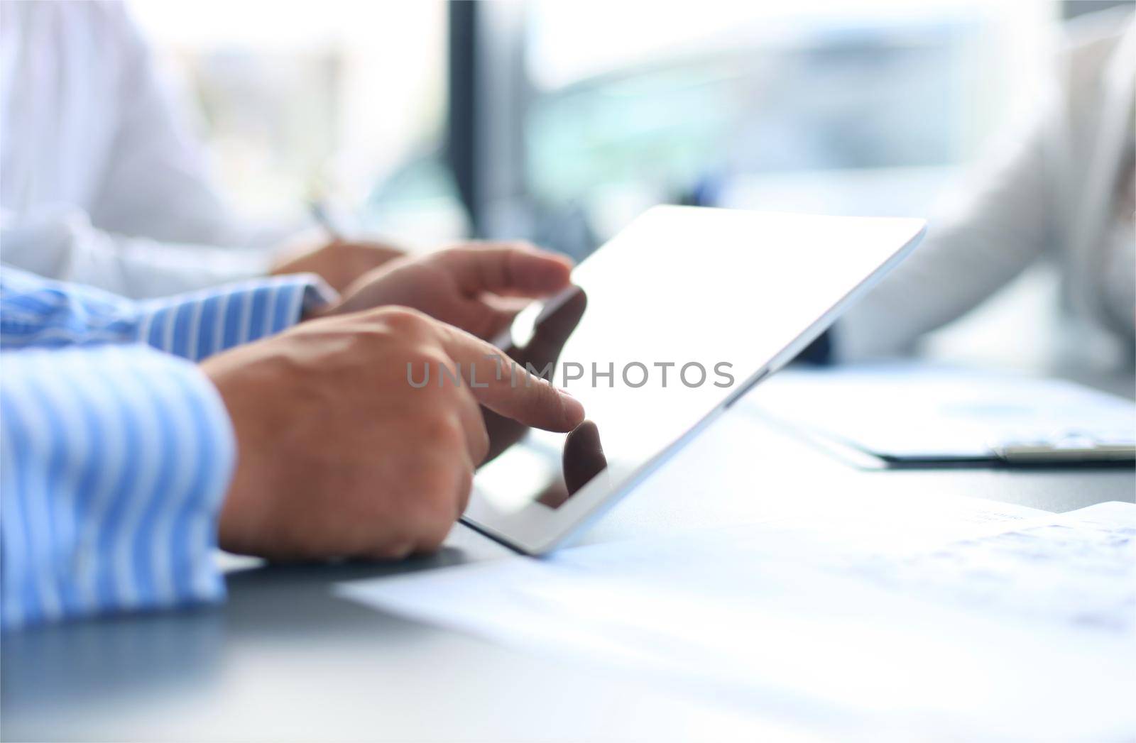 Business person analyzing financial statistics displayed on the tablet screen