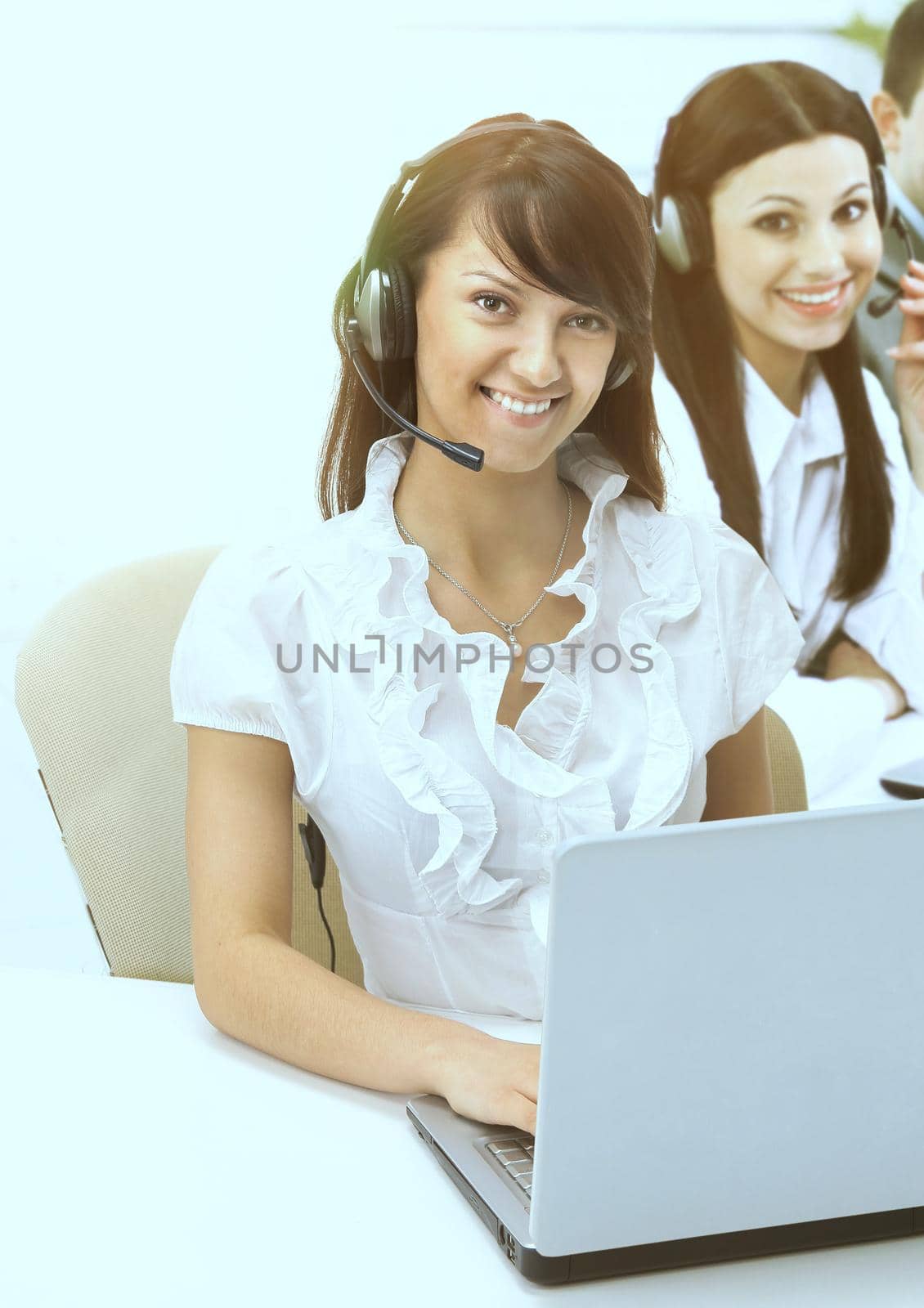 friendly group of operators sitting at the working place for the laptop. by SmartPhotoLab